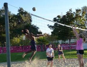 students playing sand volleyball