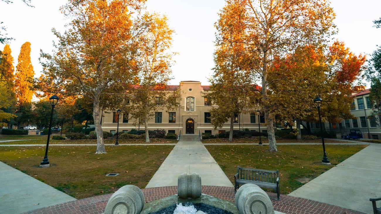 water fountain with three different walking paths leading to buildings. 